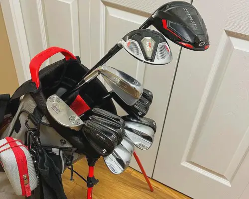 Different golf clubs in a bag.