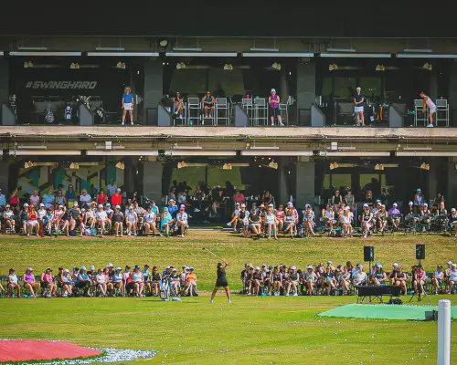 A crowd of people watching a PGA golf match.